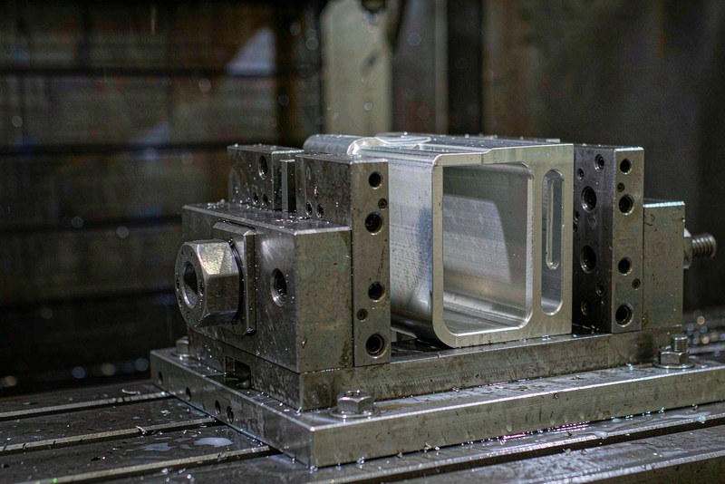 Machined aluminum part with sharp corners clamped on a fixture