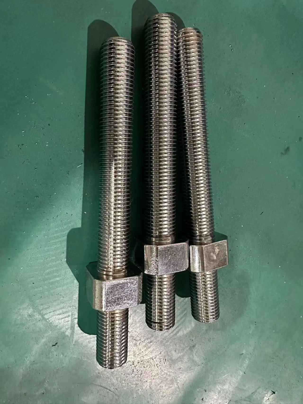 Three Hongke threaded components with hexagonal sections