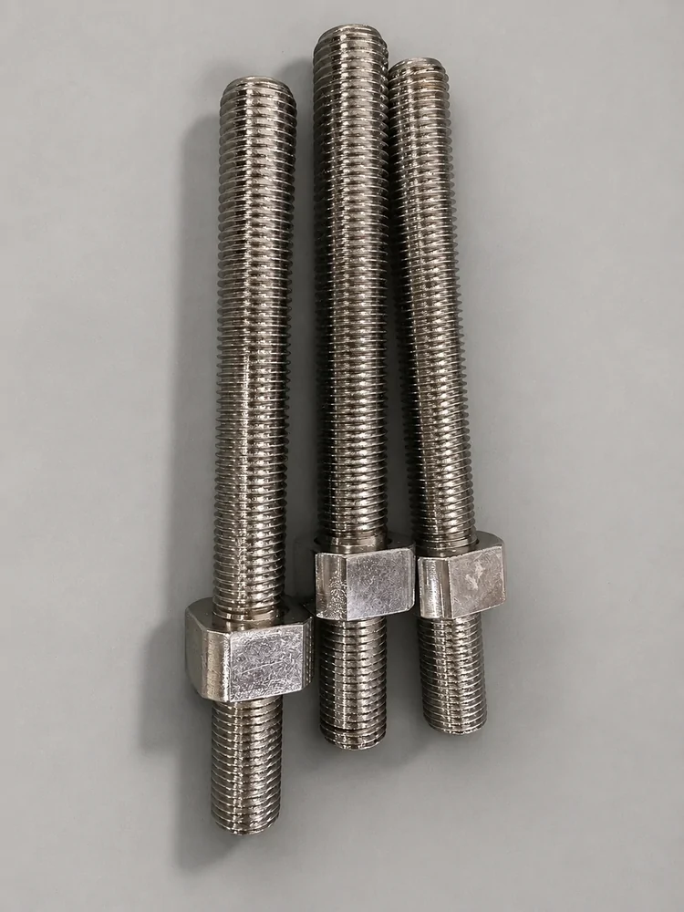 Three threaded studs with hexagonal sections