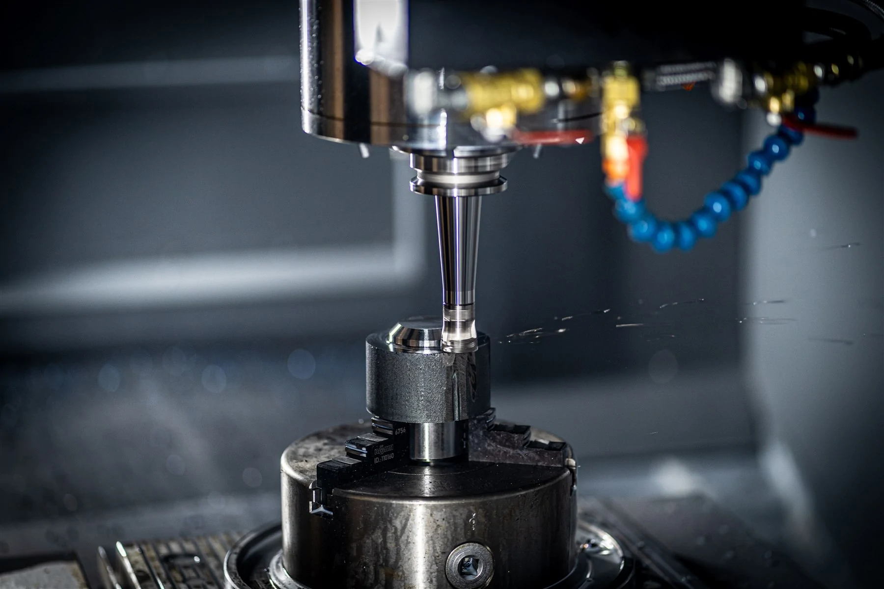 CNC milling cutter machining a clamped metal workpiece