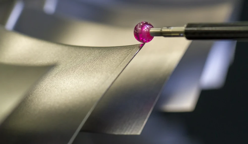 Coordinate measuring probe near a machined metal surface