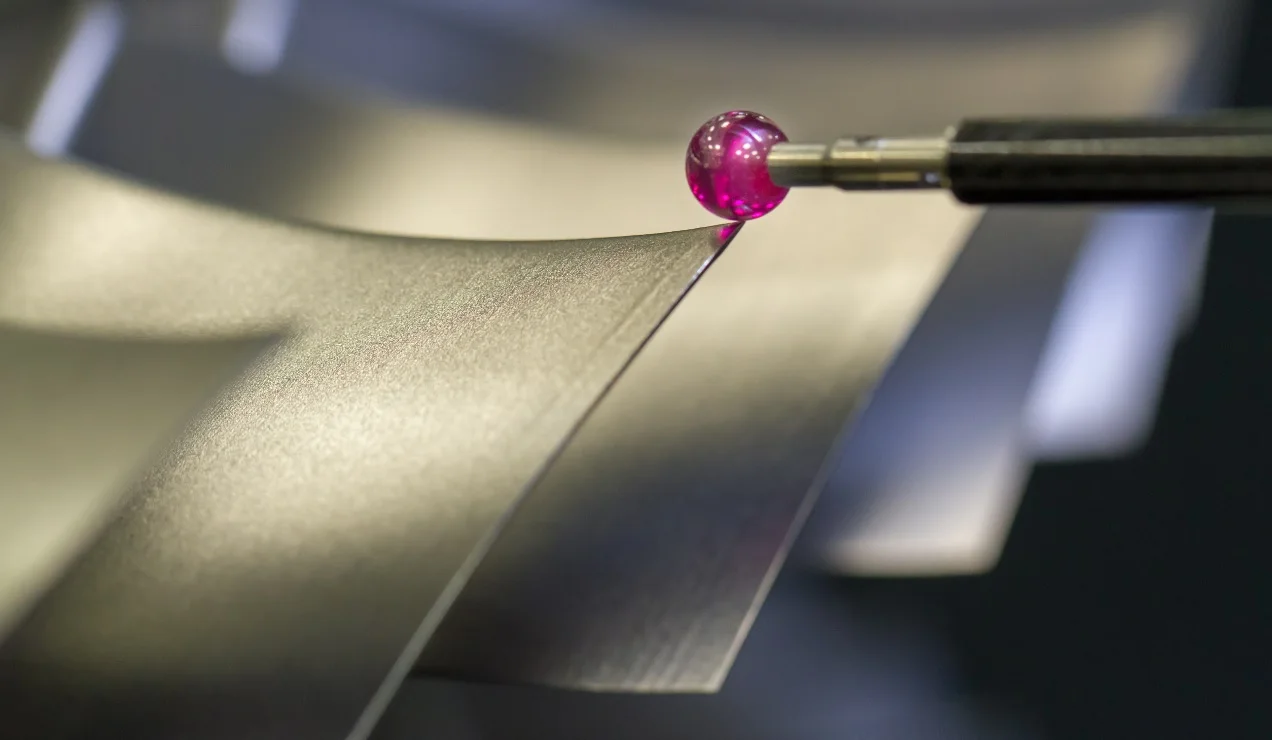 Touch probe checking a machined feature