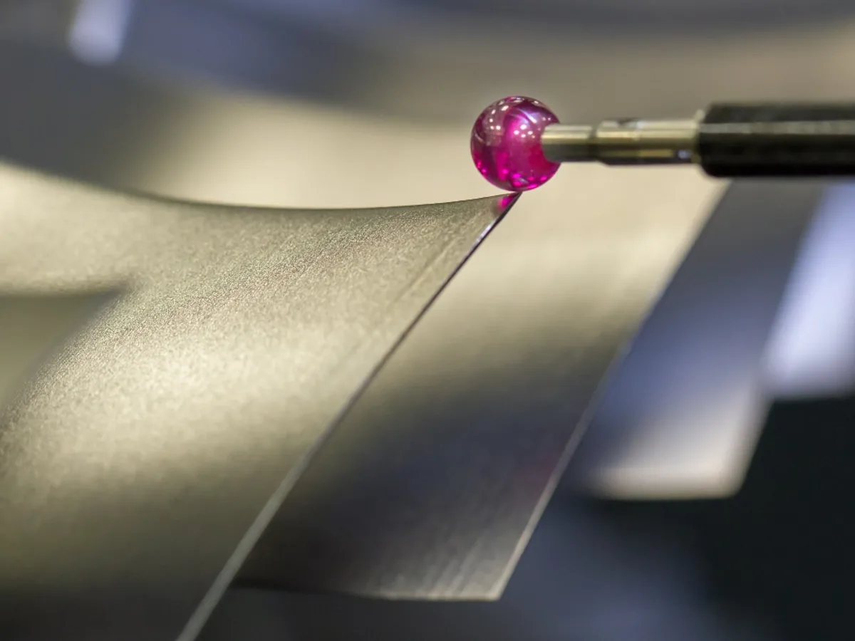 CMM touch probe contacting an accessible edge on a machined component