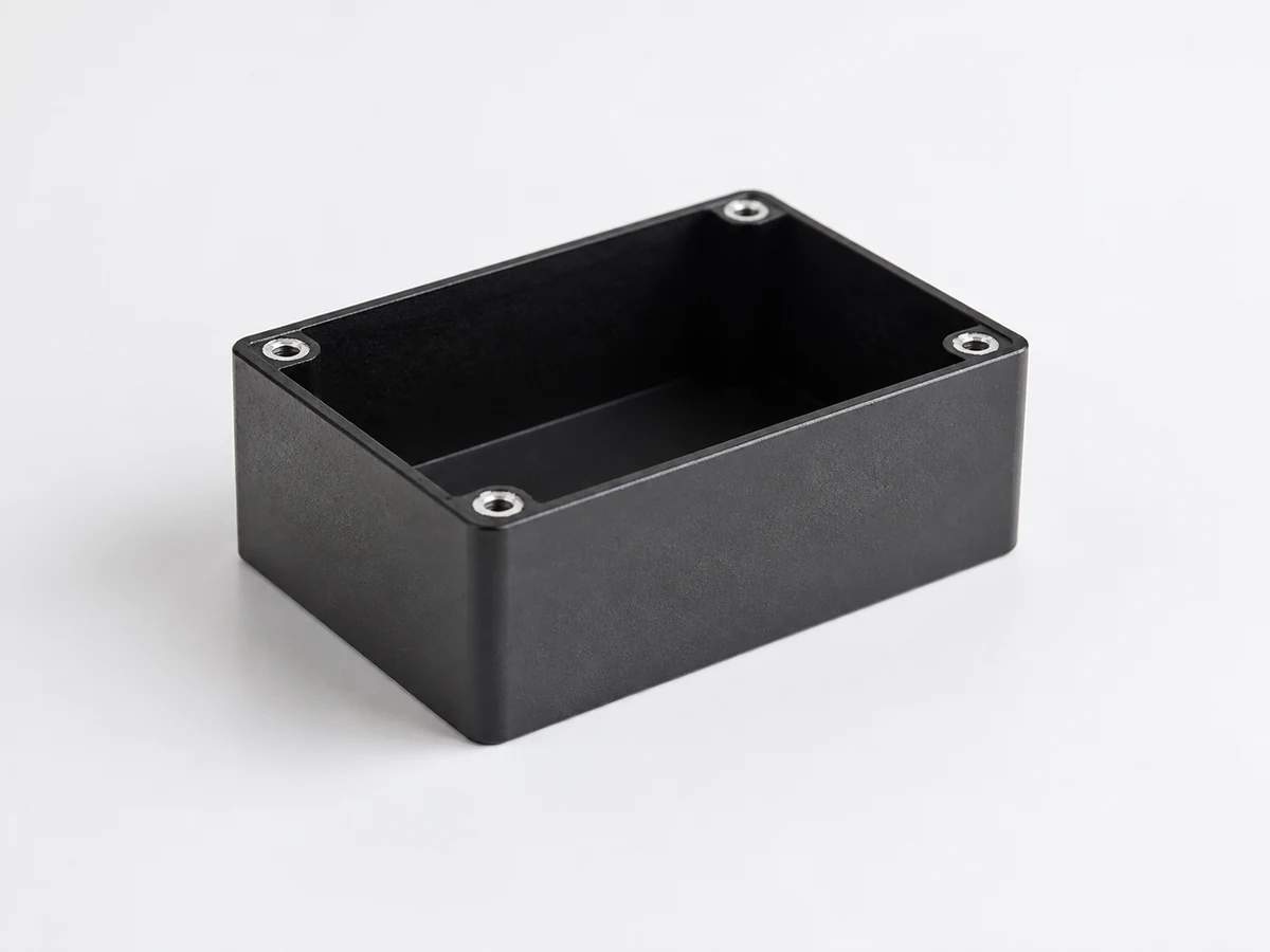 Illustrative machined enclosure with a textured dark powder coated exterior