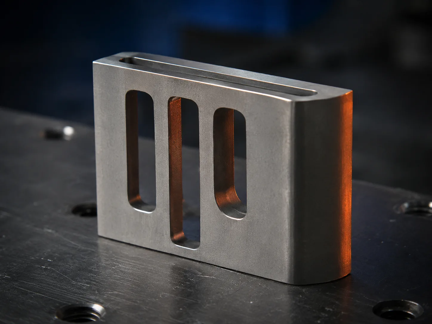 Metal component with narrow slots and thin profile sections